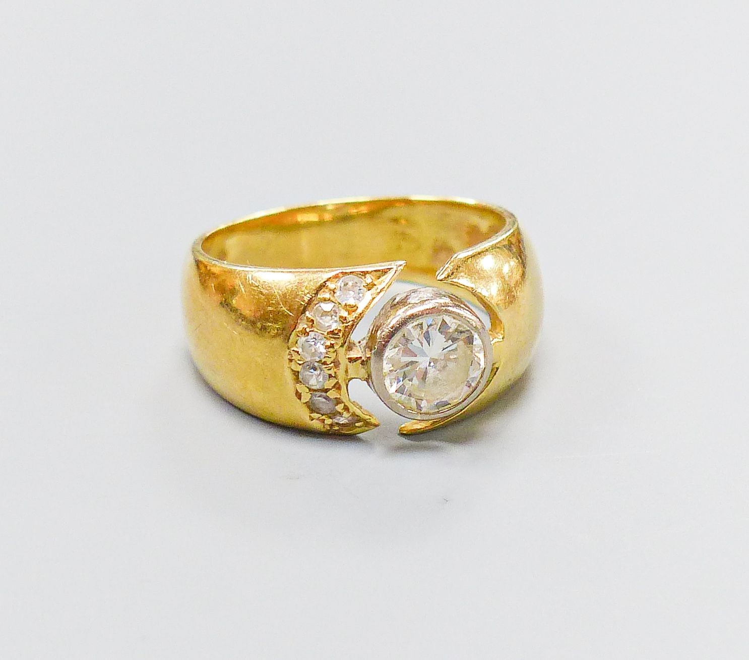 A modern 750 yellow metal and single stone diamond ring, with diamond set open work setting, size M, gross 6.4 grams.